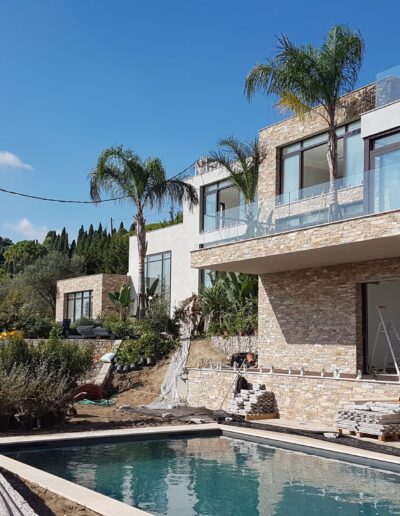 Construction works around the terrace and pool of a contemporary villa.