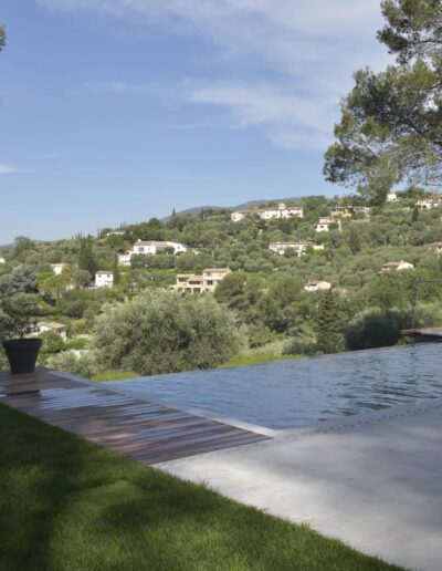 Infinity pool facing a hilly landscape with surrounding villas