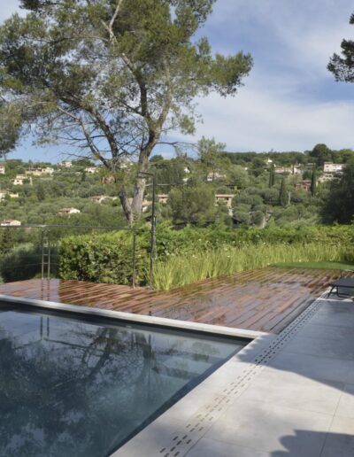 Transformed pool with modern terrace, sun loungers and refined planting design