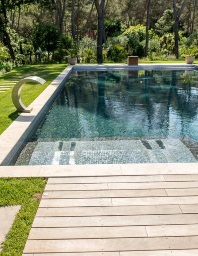 Renovated pool with wooden deck overlooking the landscaped garden