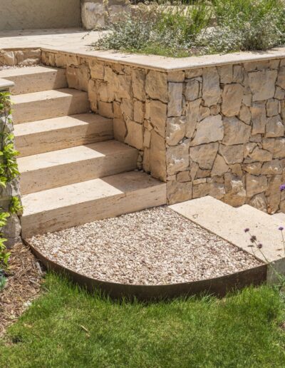 Stone staircase and mineral border integrated into the garden layout