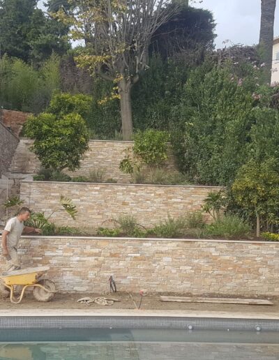 Construction of stone retaining walls and terraced garden areas.