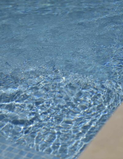 Swimming pool water with shimmering sunlight reflections