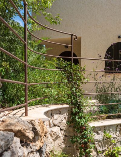 Wrought-iron railing running along the terraced garden levels